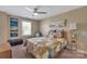 Bright bedroom with a ceiling fan, artwork, and a large window at 7046 North Bridge Dr, Huntersville, NC 28078