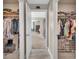 Open walk-in closets, leading to a bedroom with natural light and calming colors at 7046 North Bridge Dr, Huntersville, NC 28078