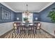 A formal dining room with a classic wooden table and elegant blue walls at 7046 North Bridge Dr, Huntersville, NC 28078