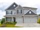 Charming two-story home with stone accents, well-maintained landscaping, and a spacious two car garage at 7046 North Bridge Dr, Huntersville, NC 28078
