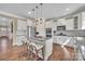 Modern kitchen with stainless steel appliances, granite countertops, a spacious island, and wood flooring at 7046 North Bridge Dr, Huntersville, NC 28078