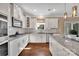 Bright kitchen featuring stainless steel appliances, granite countertops, white cabinets, and a spacious island at 7046 North Bridge Dr, Huntersville, NC 28078