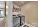 Functional laundry room with modern washer and dryer, and storage shelves for an organized space at 7046 North Bridge Dr, Huntersville, NC 28078