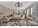 Bright living room featuring a large sectional sofa, wood flooring, and an open floor plan to the kitchen at 7046 North Bridge Dr, Huntersville, NC 28078