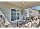Cozy covered patio with comfortable seating, stylish decor, and a view of the serene backyard at 7046 North Bridge Dr, Huntersville, NC 28078