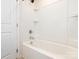 Clean white bathtub with shower and built-in storage at 709 Volta Nw Dr, Concord, NC 28027