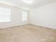 Bright and airy bedroom with neutral carpet and two windows at 709 Volta Nw Dr, Concord, NC 28027