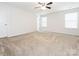 Spacious bedroom featuring neutral carpeting and two bright windows at 709 Volta Nw Dr, Concord, NC 28027