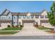 Charming townhouse with a two-car garage, stone accents, manicured lawn, and colorful exterior at 709 Volta Nw Dr, Concord, NC 28027