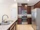 Modern kitchen with granite counters, stainless appliances, and rich cabinetry at 709 Volta Nw Dr, Concord, NC 28027