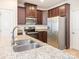 Gourmet kitchen features stainless appliances, granite countertops, rich cabinetry, and a kitchen island at 709 Volta Nw Dr, Concord, NC 28027