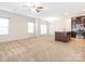 Spacious living room features plush carpeting, abundant natural light, and an open layout at 709 Volta Nw Dr, Concord, NC 28027