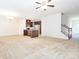 Inviting living room featuring plush carpeting, an open layout, and an adjacent kitchen and staircase at 709 Volta Nw Dr, Concord, NC 28027