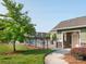 Community pool with a bath house, black aluminum fencing, and beautiful landscaping at 709 Volta Nw Dr, Concord, NC 28027