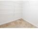 Empty walk-in closet with carpeted floor and white shelving at 709 Volta Nw Dr, Concord, NC 28027
