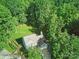 Aerial view of a lovely two-story home with a driveway and surrounded by lush green trees at 7344 Maitland Ln, Charlotte, NC 28215