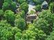 Aerial view of a home surrounded by green trees, complemented by ample parking, and a back deck at 7344 Maitland Ln, Charlotte, NC 28215