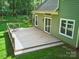 A backyard deck with steps, offering an outdoor space, and a view of the lawn at 7344 Maitland Ln, Charlotte, NC 28215