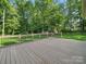 A backyard deck offering an outdoor space, with a lawn and bordered by a wooden fence at 7344 Maitland Ln, Charlotte, NC 28215