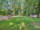 A backyard with a shed, a fence, and mature trees, creating a private outdoor space at 7344 Maitland Ln, Charlotte, NC 28215