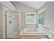 Bathroom features a separate shower and a large soaking tub under a window at 7344 Maitland Ln, Charlotte, NC 28215