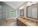 Bathroom features a double granite vanity, separate shower, and a large soaking tub under a window at 7344 Maitland Ln, Charlotte, NC 28215