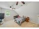 Bedroom includes vaulted ceiling, ceiling fan, and a window for natural light at 7344 Maitland Ln, Charlotte, NC 28215