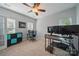 Bright bedroom featuring dual monitors, a wood desk, a ceiling fan, and carpet floors at 7344 Maitland Ln, Charlotte, NC 28215