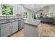 Kitchen area with white cabinets, stainless steel appliances, granite countertops and a sink with a view at 7344 Maitland Ln, Charlotte, NC 28215