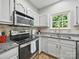 Close up view of a well equipped kitchen with stainless steel appliances and granite countertops at 7344 Maitland Ln, Charlotte, NC 28215