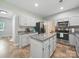 Bright kitchen features white cabinets, stainless steel appliances, and an island with granite countertops at 7344 Maitland Ln, Charlotte, NC 28215
