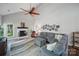 Bright living room with vaulted ceilings, a fireplace, hardwood floors, a ceiling fan and comfortable sofas at 7344 Maitland Ln, Charlotte, NC 28215