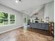 Open-concept living room with fireplace, neutral paint, and lots of natural light at 7344 Maitland Ln, Charlotte, NC 28215