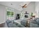 Bright living room with vaulted ceilings, a fireplace, hardwood floors, and sliding door access to the deck at 7344 Maitland Ln, Charlotte, NC 28215
