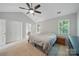 Bright main bedroom features neutral walls, vaulted ceilings with ceiling fan, and ensuite access at 7344 Maitland Ln, Charlotte, NC 28215