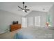 Spacious main bedroom features neutral walls, vaulted ceilings with ceiling fan, and ensuite access at 7344 Maitland Ln, Charlotte, NC 28215