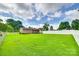 Expansive backyard enclosed by a white fence, offering ample green space for recreation and relaxation at 739 Springdale Rd, Rock Hill, SC 29730