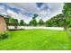 Well-manicured backyard with a patio, green lawn, white fencing, and lush trees at 739 Springdale Rd, Rock Hill, SC 29730