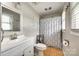 Bright bathroom with a white vanity, shower with curtain, and neutral-toned tiles at 739 Springdale Rd, Rock Hill, SC 29730