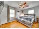 Charming bedroom featuring a wooden bed frame, hardwood floors, and natural light from two windows at 739 Springdale Rd, Rock Hill, SC 29730