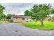 Charming brick home with a gravel driveway, grassy front yard, and mature trees at 739 Springdale Rd, Rock Hill, SC 29730