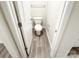 Cozy powder room features a modern toilet, new flooring, and neutral wall paint at 7601 Hammond Dr, Charlotte, NC 28215