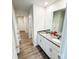 Bright bathroom featuring double sink vanity with granite countertop and modern fixtures at 7601 Hammond Dr, Charlotte, NC 28215