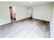 Spacious bedroom with neutral walls, modern gray vinyl flooring, and ample natural light at 7601 Hammond Dr, Charlotte, NC 28215