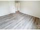 Spacious bedroom with neutral walls, modern gray vinyl flooring, and ample closet space at 7601 Hammond Dr, Charlotte, NC 28215