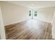 Bright bedroom with wood-look flooring and windows offering outside views at 7601 Hammond Dr, Charlotte, NC 28215
