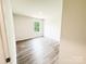 Bedroom with new flooring and natural light streaming through the window at 7601 Hammond Dr, Charlotte, NC 28215