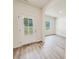 Clean and bright entryway featuring wood-look floors, neutral walls, and a door to the exterior at 7601 Hammond Dr, Charlotte, NC 28215