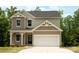 Beautiful two-story home with neutral siding, attached two car garage, and a well-maintained yard at 7601 Hammond Dr, Charlotte, NC 28215