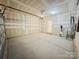 Spacious garage with a water heater and an unfinished drywall interior, offering plenty of potential at 7601 Hammond Dr, Charlotte, NC 28215